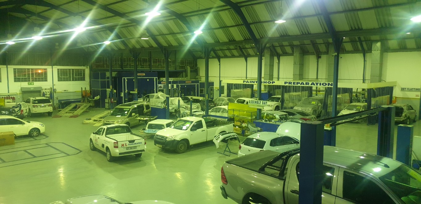 M&L Panelbeaters workshop with different vehicles that are repaired and still being repaired