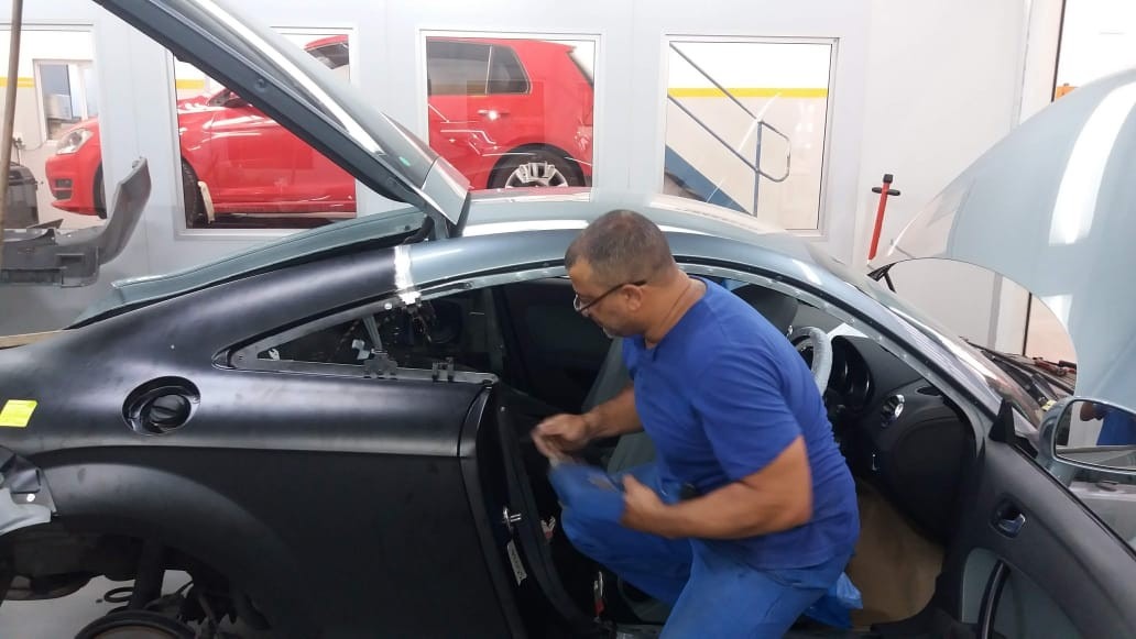 M&L Panelbeaters mechanic repairing vehicle